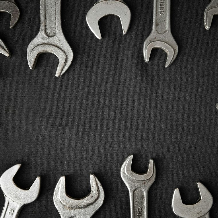 Wrenches arranged in a circle on a dark background